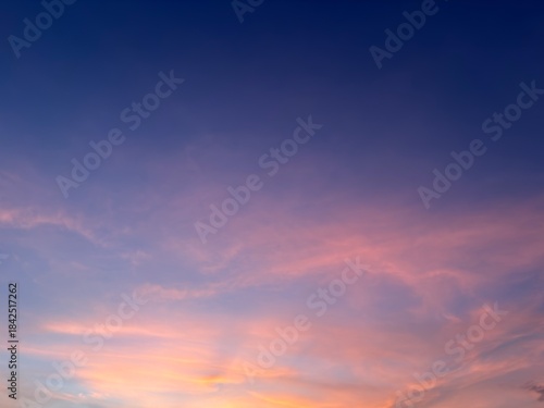 Beautiful sunset sky with soft clouds and smooth gradient colors from blue to pink and orange. Natural evening atmosphere, calm mood, perfect for background, wallpaper, and nature concepts.