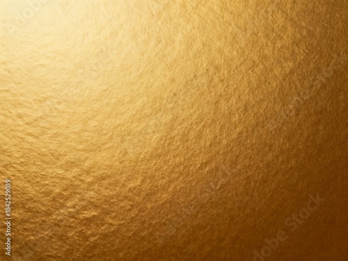 Close-up of a textured golden surface with a gradient lighting effect