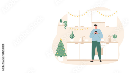 Man uses smartphone in a festive modern kitchen decorated for Christmas holidays