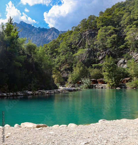 Small pond in the mountains with turquoise water in Goynuk canyon,  Turkey. Emerald lake in the forest surround mountains.