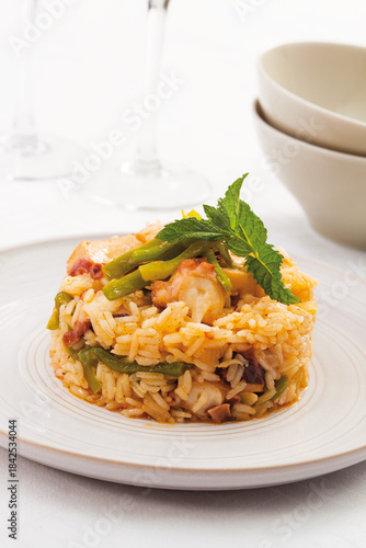 Baked rice with octopus and seasonal vegetables.
