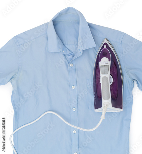 Top view of a purple electric iron placed on a light blue shirt while ironing