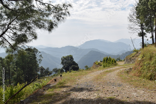 Beautiful green mountain with blue and white clouds in the sky.