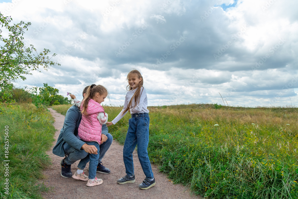Fototapeta premium Father and children have fun, laugh and enjoy nature outdoors.