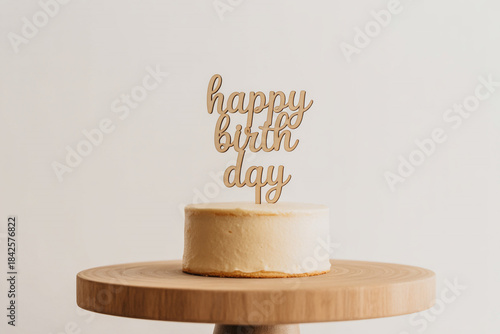 Delicious birthday cake with happy birthday sign on wooden stand
