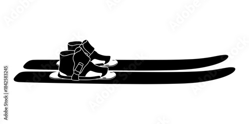 Pair of classic cross-country skis with bindings and boots, ready for winter sports.