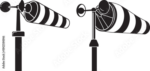 Two striped windsocks on poles silhouette
