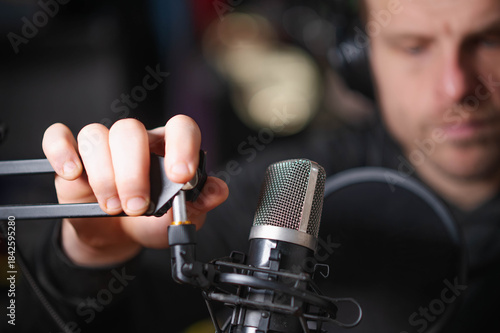 podcaster with microphone copy space background image, selective focus image, horizontal, white male, model, handsome guy