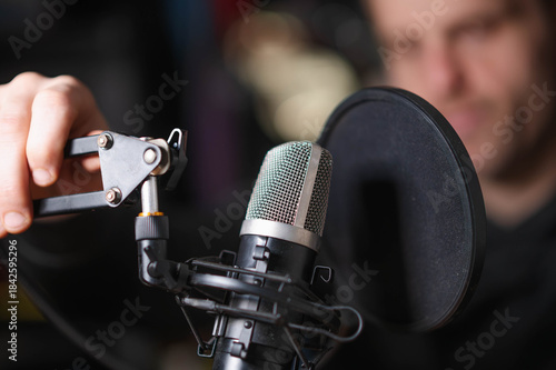 podcaster with microphone copy space background image, selective focus image, horizontal, white male, model, handsome guy
