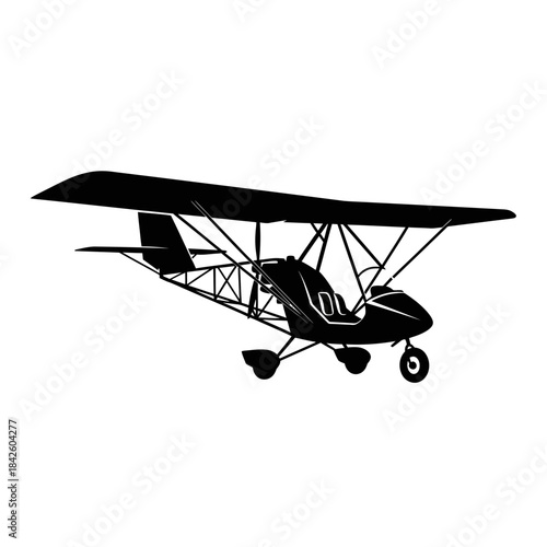 Silhouette of a Light Sport Aircraft Ultralight Plane Flying.