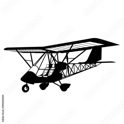 Silhouette of a light sport aircraft or ultralight plane flying.