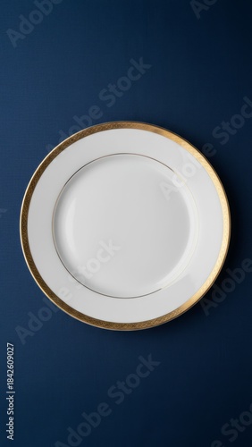 Elegant White Ceramic Plate with Gold Rim on Dark Blue Tablecloth for Fine Dining Setting | Photorealistic 8k Image Ready for Food Compositing