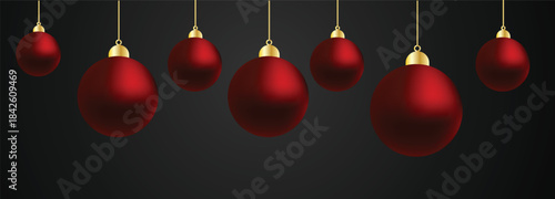 A row of red christmas ornaments hanging from gold strings on a dark background with a white space below them for text or other design elements to be added for holiday greeting or festive decoration p