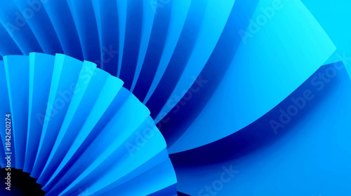 Blue pleated fan shaped paper decoration in shades of azure and cobalt, resembling a spiral or swirling motion