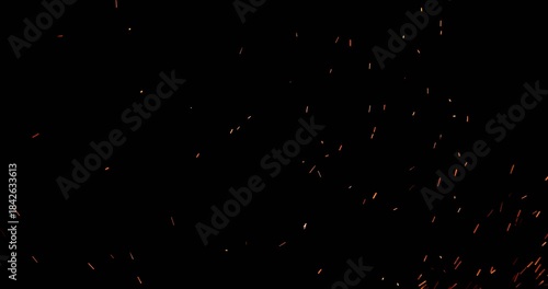 Realistic fire sparks flying through the air in ultra slow motion, isolated on a black background. Perfect as a cinematic VFX overlay, fire particles effect or visual element. Shot in slow motion.