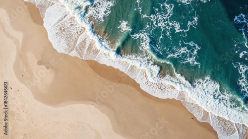 Aerial view of ocean waves meeting pristine sandy beach, showcasing dynamic tide patterns. Use: travel brochure cover, environmental documentary.