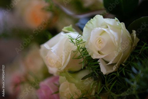 Beautiful white roses arranged with green foliage in a floral display for a special event