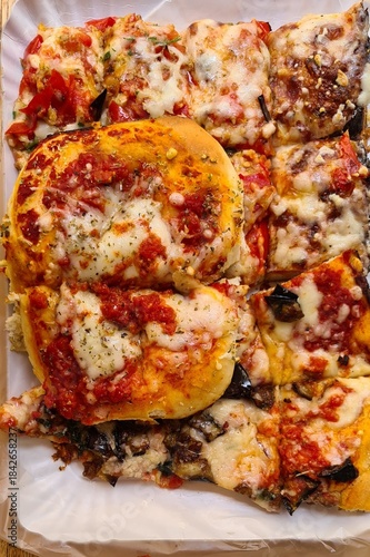 Evocative image of pizza slices with tomato sauce, mozzarella, and eggplant ready to be savored
