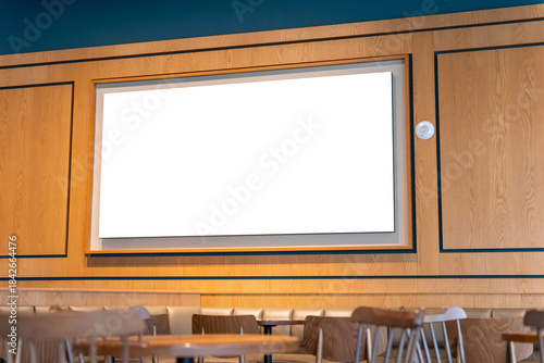 Blank screen mockup on modern wooden wall in a stylish coffee shop, Empty advertising billboard inside a cafe with copy space for menu or promotional message, Horizontal blank sign on timber wall