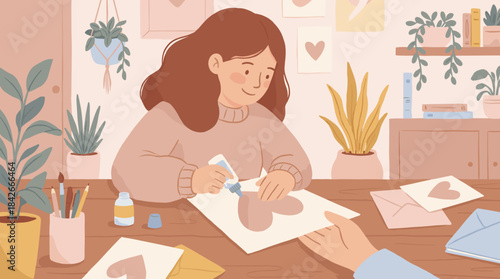 Smiling young woman with brown hair makes a handmade greeting card with a heart, using glue at a wooden table in a cozy room filled with many lovely houseplants