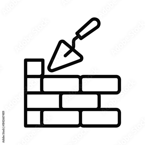 Brick wall with trowel isolated on, symbolizing construction, masonry, and building trades