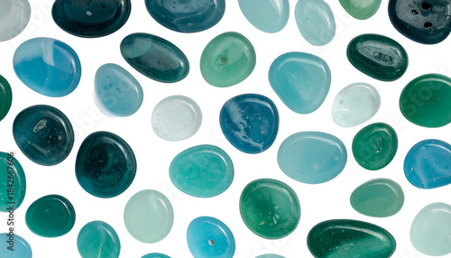 Various shades of cool toned polished stones against a solid black backdrop