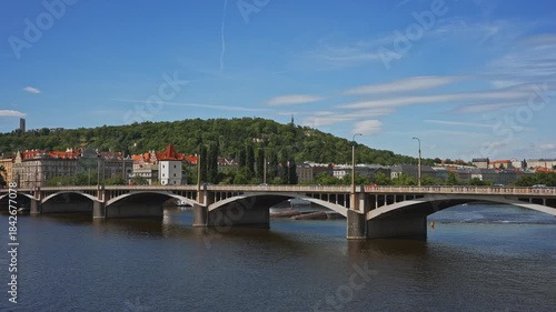 Famous Prague stone bridge with buildings.