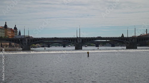 Famous Prague stone bridge with buildings.
