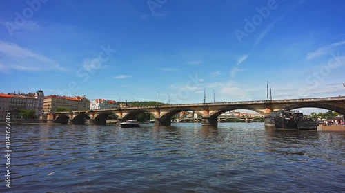 Famous Prague stone bridge with buildings.