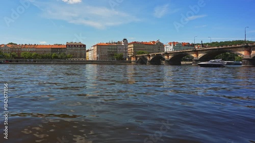 Famous Prague stone bridge with buildings.