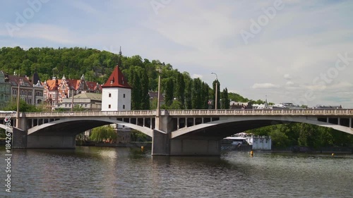 Famous Prague stone bridge with buildings.