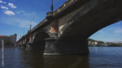 Famous Prague stone bridge with buildings.