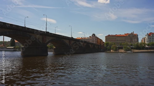 Famous Prague stone bridge with buildings.