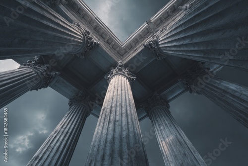 Majestic columns rise toward a stormy sky, showcasing timeless architecture and strength under a dramatic, low-angle perspective.