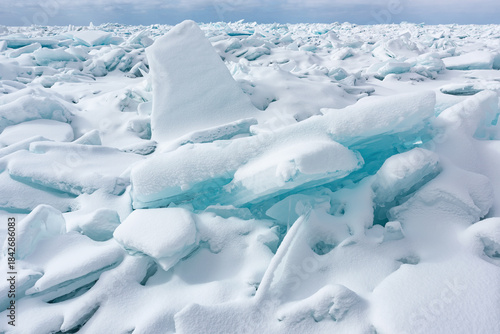 Winter landscape of blue ice shards and the snow covered shoreline of Lake Michigan, Empire Beach, Sleeping Bear Dunes, Michigan, USA