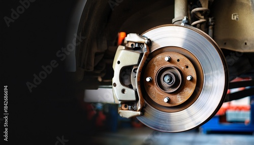 closeup of disc brake in car repair auto maintenance in garage with space for text