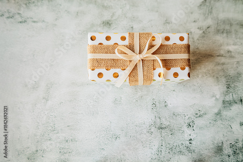 Wallpaper Mural Single elegant present with polka dots and jute ribbon on concrete backdrop. Perfect layout for product mockups, packaging tutorials, and holiday marketing visuals Torontodigital.ca