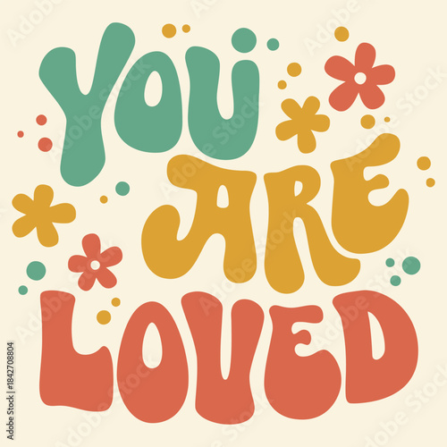 Retro groovy typography design proclaiming you are loved with colorful flowers and abstract shapes