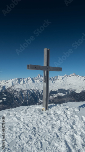 woodden cross on folluhorn summit during winter , switzerland