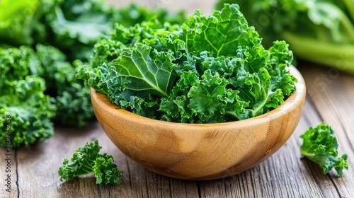 Leafy kale in bowl, still wet from washing, sits on warm wooden texture, reflecting freshness and mindful nutrition