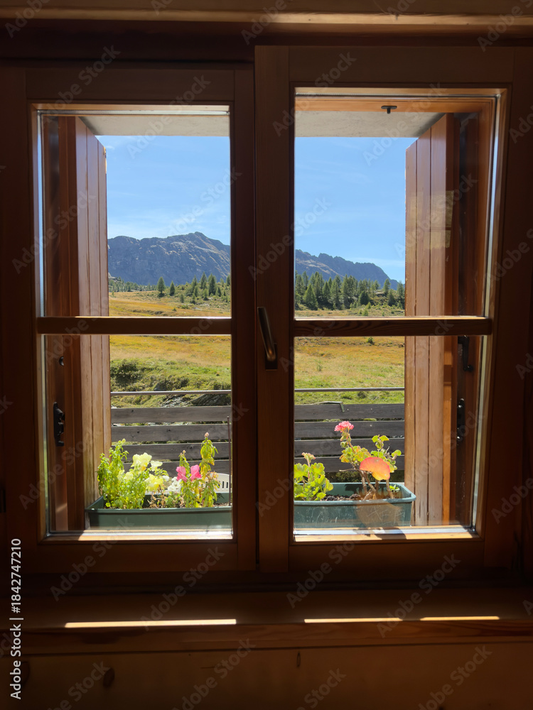 Fototapeta premium the beautiful Alpine landscape seen from the window of a chalet