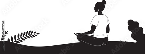Silhouette of a woman sitting in a peaceful yoga meditation pose
