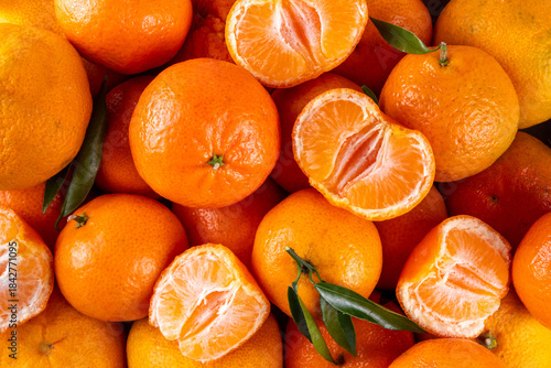 Fresh tangerines, mandarin clementines, raw farm organic citrus fruits, with stems and leaves, for sale at market 