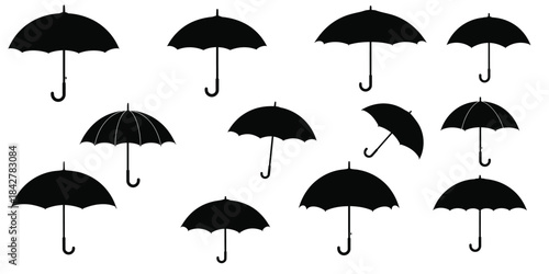 Collection of black umbrellas on white background