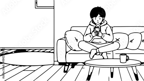 A young person sitting on a couch, engrossed in their smartphone, with a mug on the coffee table in a home setting.