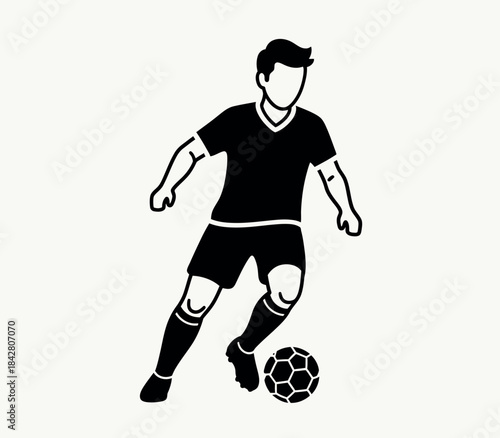 Soccer player kicking a ball in action pose