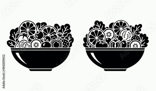 Two black bowls overfilled with various fruit slices