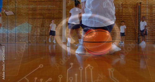 Kid kneeling holding basketball in gym, coach timing, overlay rotating around ball guiding PE drill