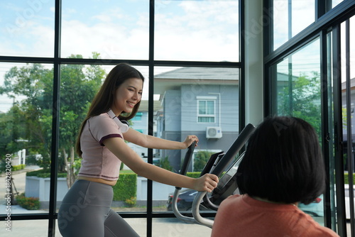 Wallpaper Mural Personal trainer guiding woman during workout session in gym Torontodigital.ca