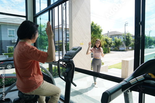 Wallpaper Mural Personal trainer guiding woman during workout session in gym Torontodigital.ca